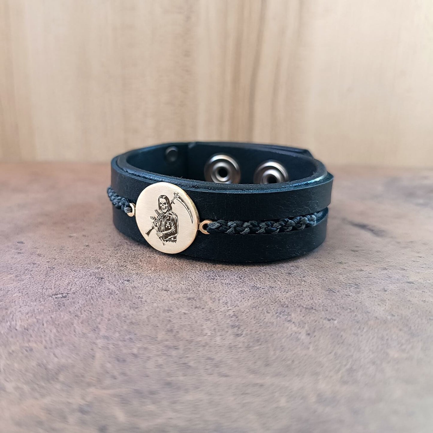 SAMCRO Black leather bracelet with a gold Reaper pendant side close up view
