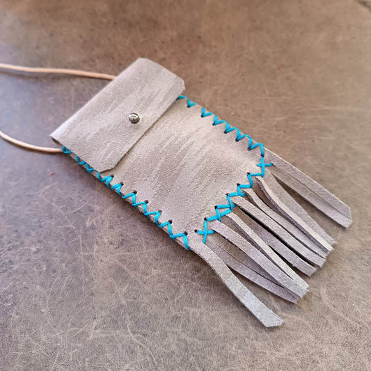 Shimmering Gray Leather Neck Bag, crafted from upcycled upholstery leather, with playful fringe and hand-stitched turquoise waxed cord. An organic cotton cord is tied at the top.