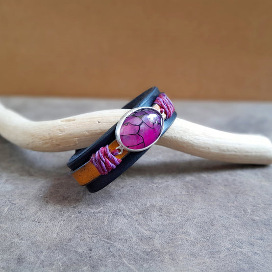 Side View of The Dragon Heart Bracelet: An OOAK leather cuff featuring a large Natural Purple Dragon Veins Agate cabochon set in hand-crafted Sterling Silver. Shows the full two-layered leather band.