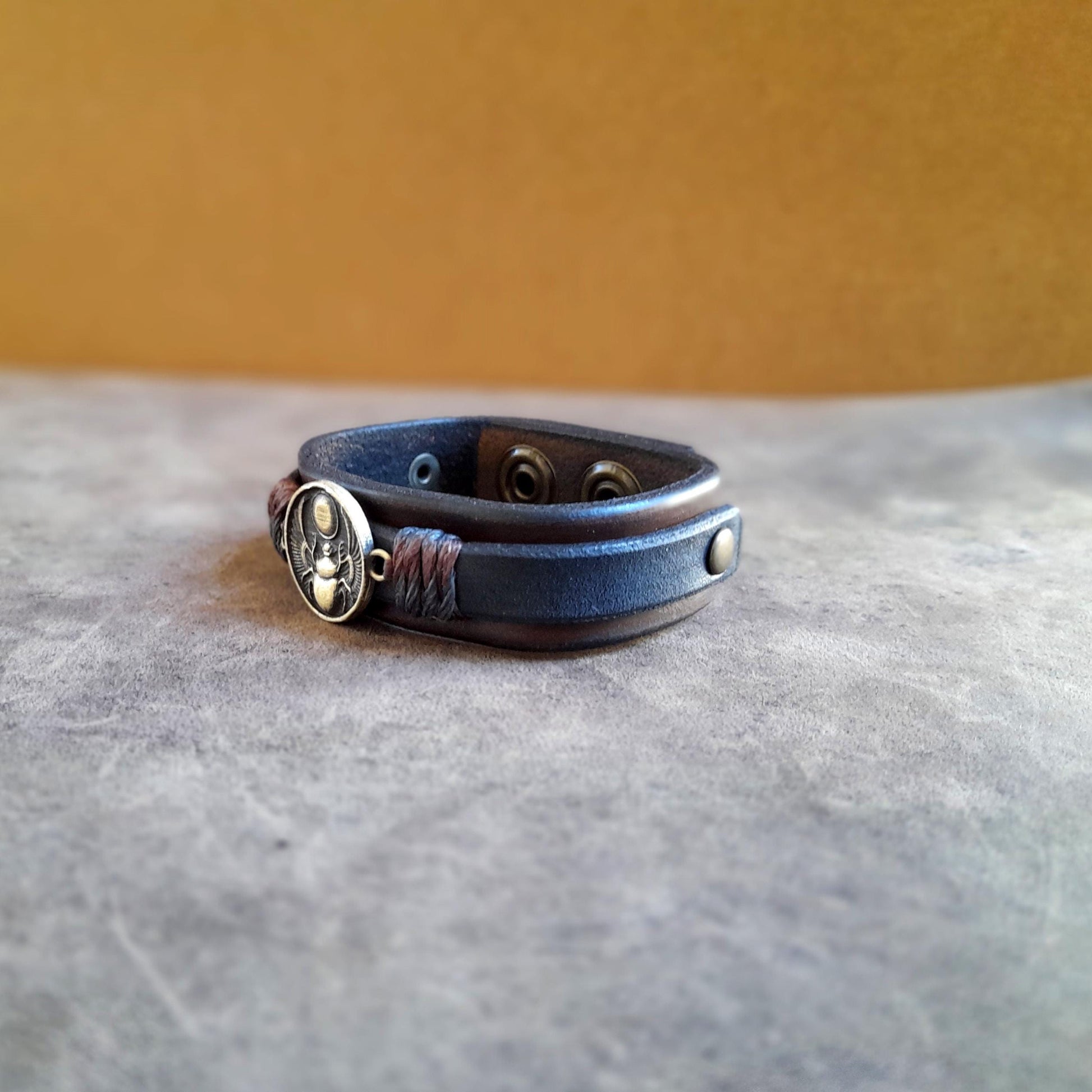 Side View of the Layered Vachetta leather band with handcrafted brass charm