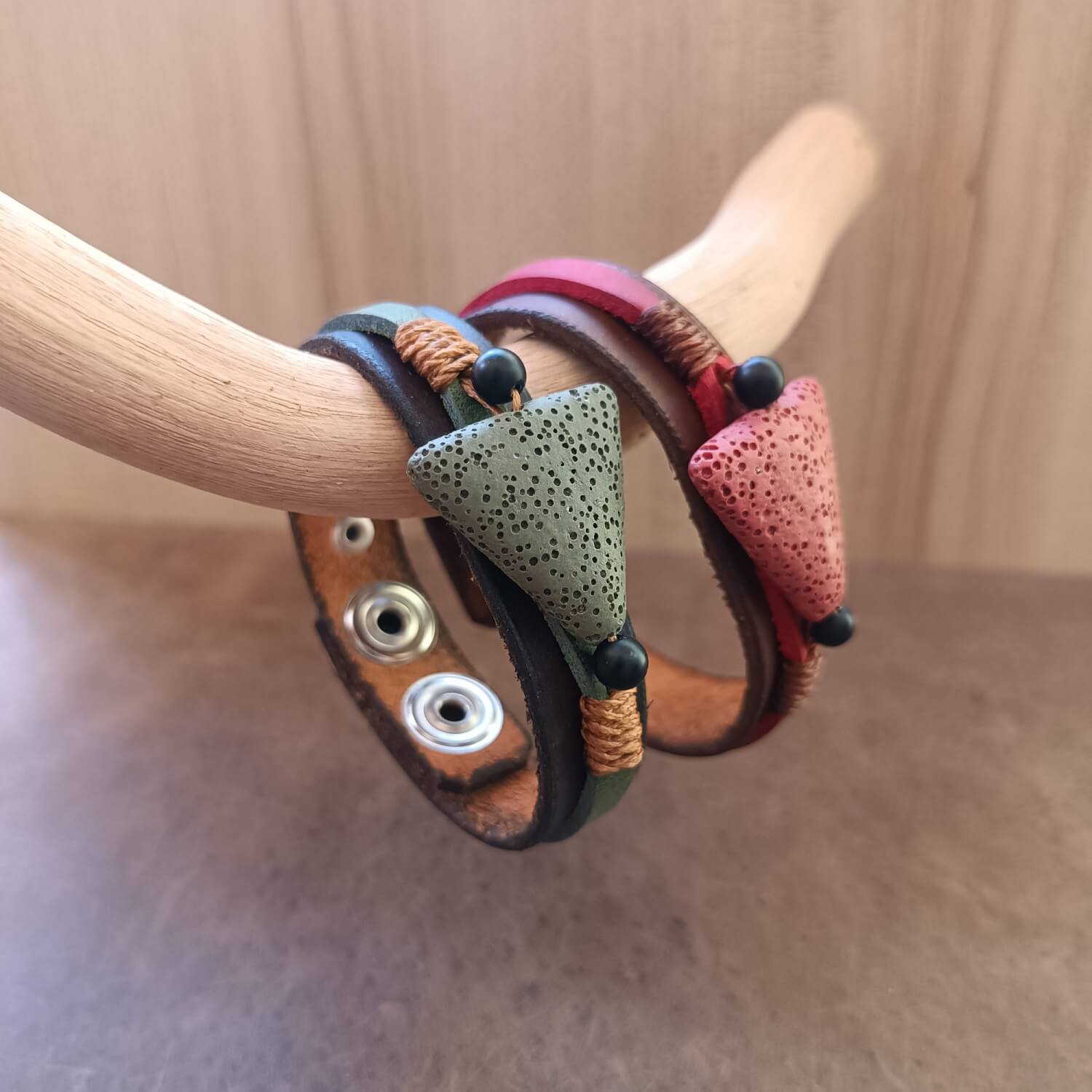 Side view of The Earth's Pulse Bracelets duo, emphasizing the layered design of the 1.6 cm wide Crazy Horse leather bands and the integration of the lava and onyx beads.