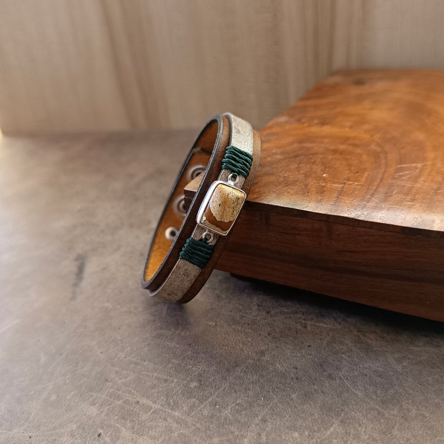 Side view of The Silent Witness Bracelet, showing the thickness and layers of the 1.6 cm wide vachetta leather band with its velvet-soft underside.