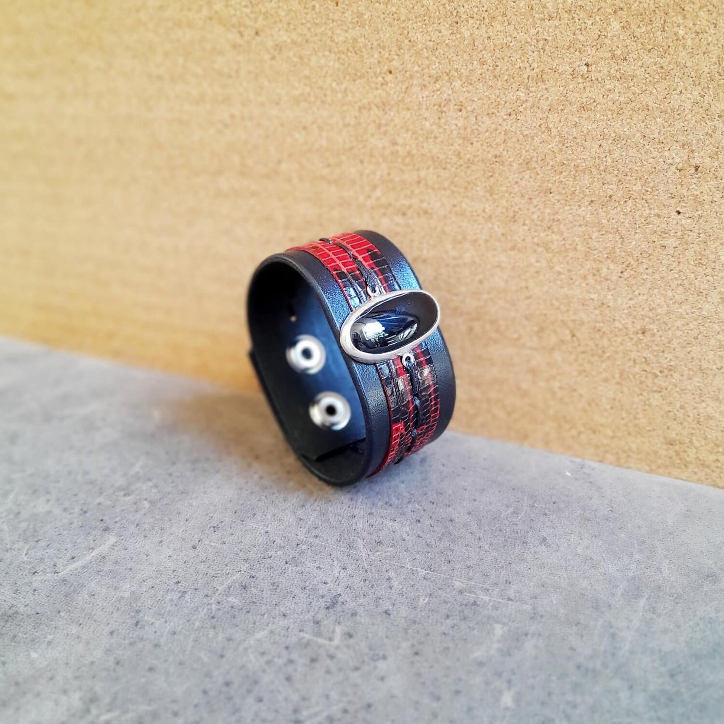 Side view of the Black Obsidian leather cuff, showing layered leather and silver pendant.
