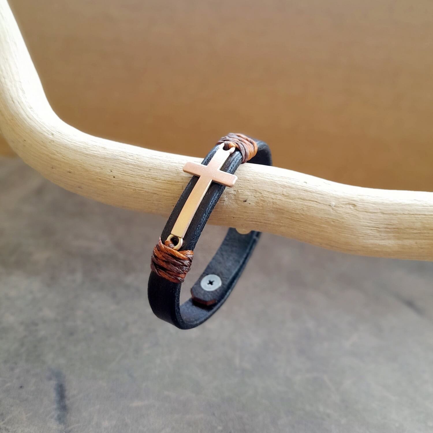 Slim leather band with rose gold cross and double stud closure