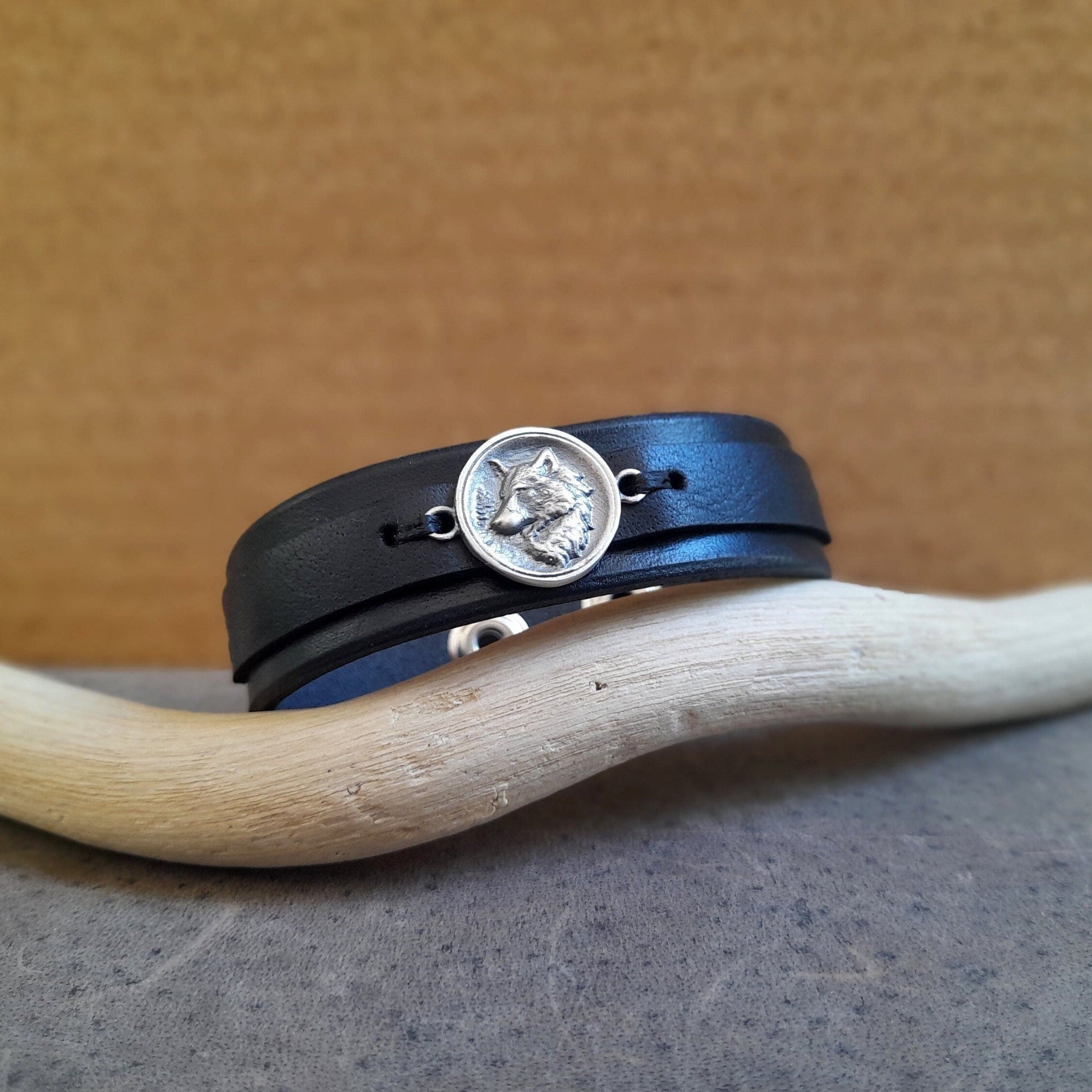 Sterling silver wolf pendant on black leather bracelet