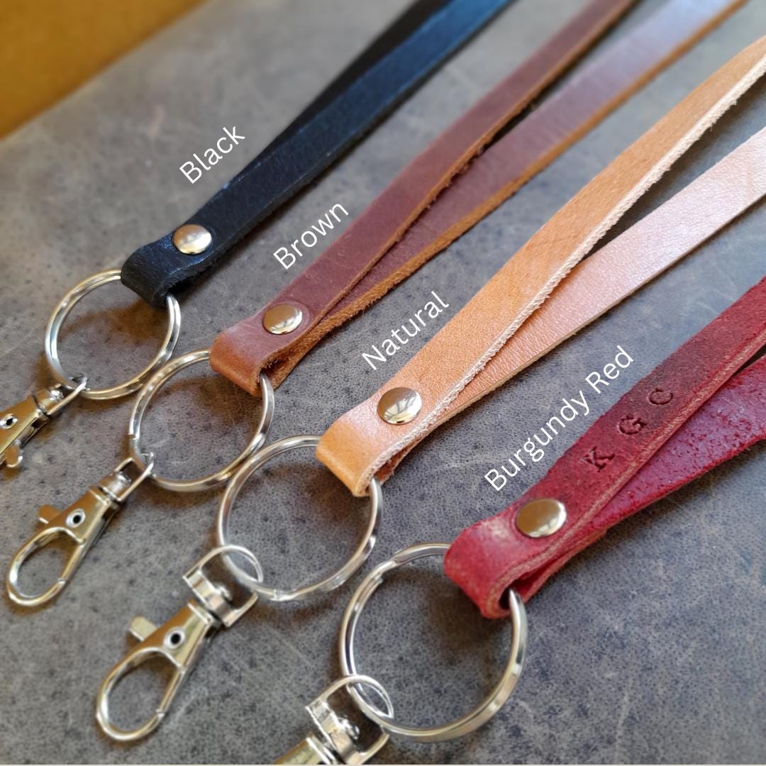 Close-up of the large 3cm heavy-duty brass split ring and stainless steel lobster clasp on The Adapt Lanyard's main lanyards group photo, emphasizing durability and space for multiple items.