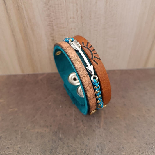 A layered multistrand leather bracelet inspired by the Scout’s prestigious Arrow of Light award, featuring a silver arrow and engraved 7 rays sun.