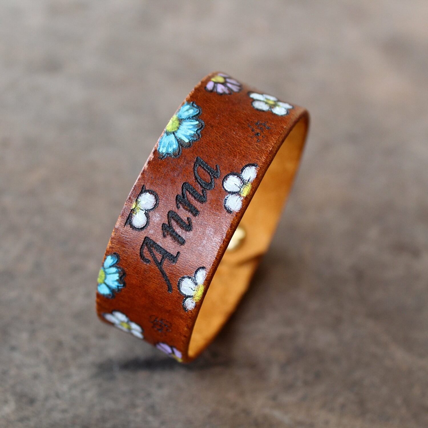 The Bloom & Name Bracelet as made for a custom order, showcasing its 2 cm wide profile, hand-painted floral design, and personalized name.