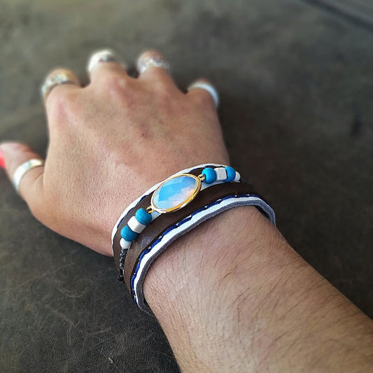 The Boho Opal Cuff worn on a woman's wrist, demonstrating its comfortable fit, wide design, and how it complements a casual or dressed-up look.