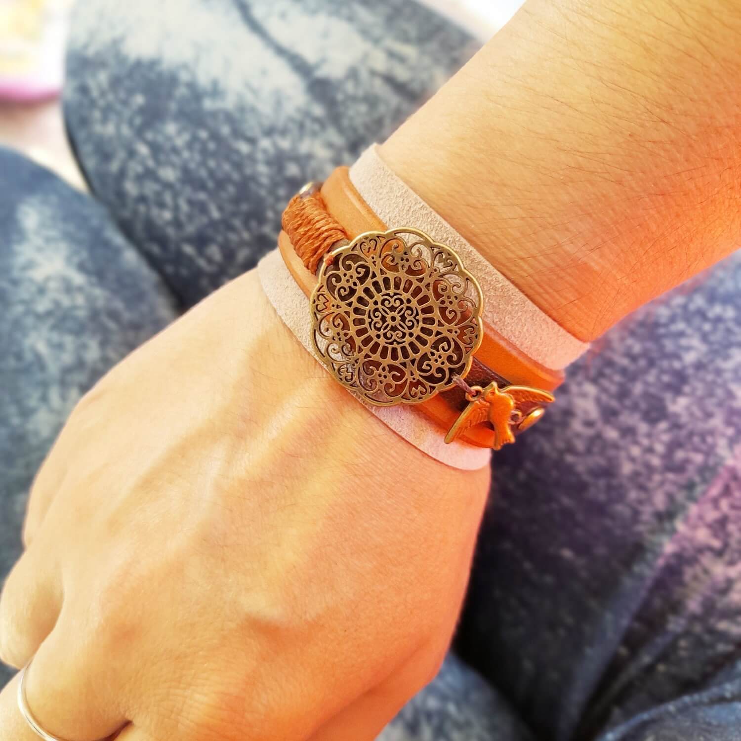 The "Happy Beige" Mandala Cuff worn on a wrist, demonstrating its comfortable fit, neutral aesthetic, and how it complements an outfit.