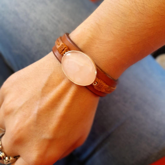 The Large Rose Quartz Leather Cuff worn on a woman's wrist with casual outfit, demonstrating its substantial size, comfortable fit, and feminine style, despite its bold appearance.