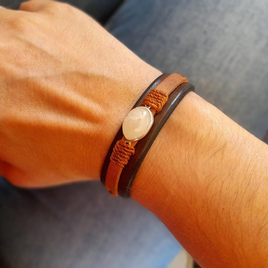 The Moonstone Glow Bracelet worn on a wrist, demonstrating its comfortable fit, narrow design, and versatile appeal for any gender.