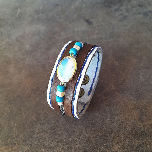 The OOAK Boho Opal Cuff: A wide white full-grain leather bracelet with dark brown suede stripes, featuring an opal pendant, white howlite, and turquoise beads in discreet macramé, with two snap closures.