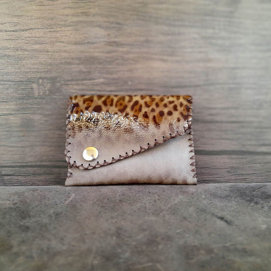 The OOAK Glossy Leopard Print Leather Wallet: A compact, hand-stitched wallet in gleaming leopard print, designed with a single compartment for essentials.