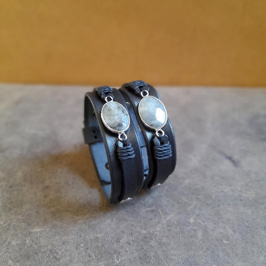 The OOAK Mystic Labradorite Wrap bracelet: a black full-grain leather, layered watchband-style bracelet featuring a gray Labradorite pendant wrapped with black waxed cord and gold-tone brass.