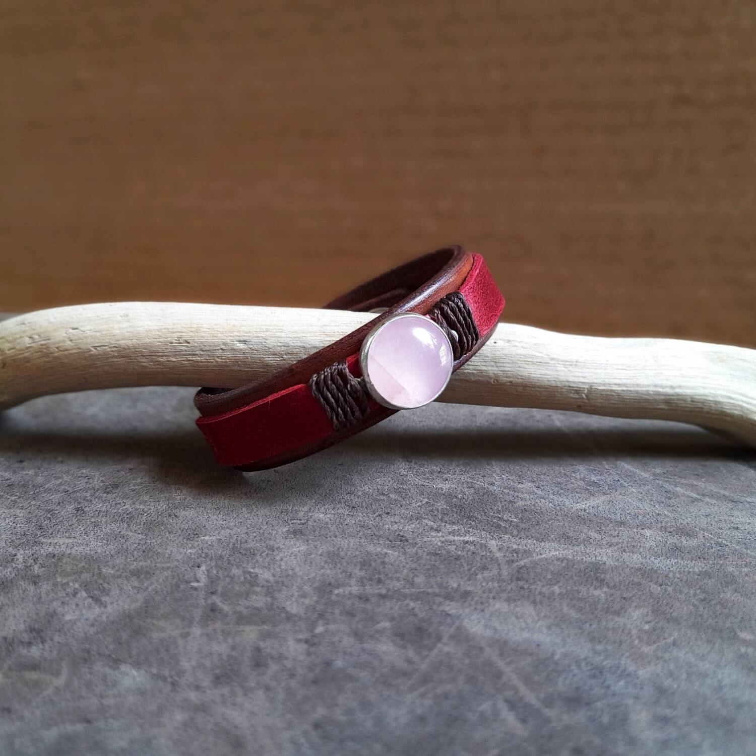 The OOAK Red Leather Bracelet with Natural Rose Quartz: A layered brown and raspberry red full-grain leather bracelet featuring a natural rose quartz stone on a sterling silver pendant.