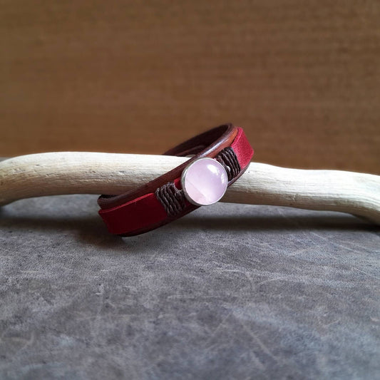 The OOAK Red Leather Bracelet with Natural Rose Quartz: A layered brown and raspberry red full-grain leather bracelet featuring a natural rose quartz stone on a sterling silver pendant.