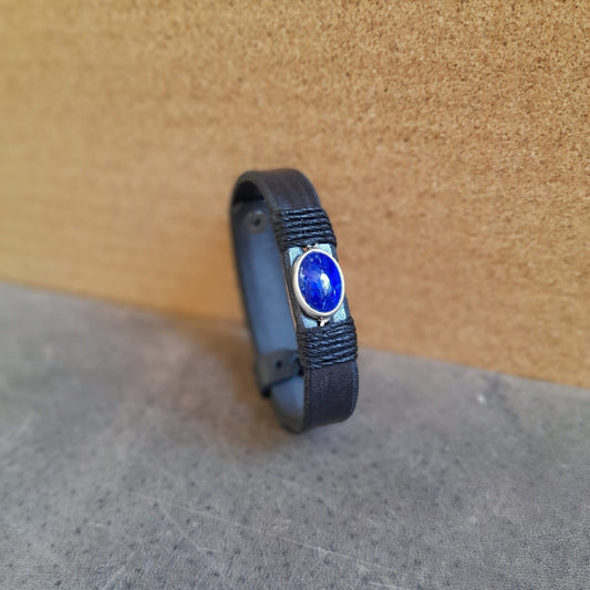 The OOAK Sodalite Clarity Bracelet: A sleek black full-grain leather single-band bracelet featuring an oval natural sodalite stone on a sterling silver pendant, wrapped with black cord.