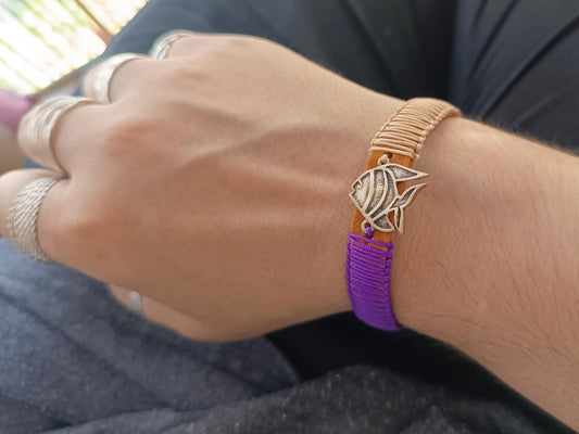 Close-up of a wrist wearing the koi fish leather bracelet