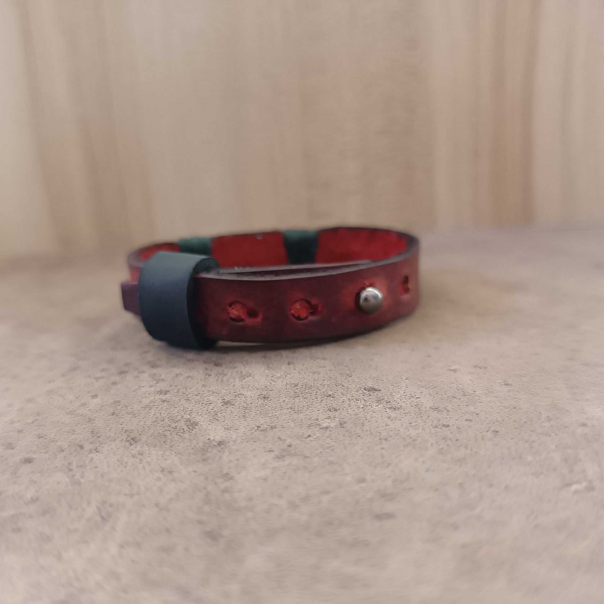 Close-up back view of the Stainless Steel Stud Button closure and black leather loop on The Rooted Glow Bracelet, illustrating its secure and practical design.