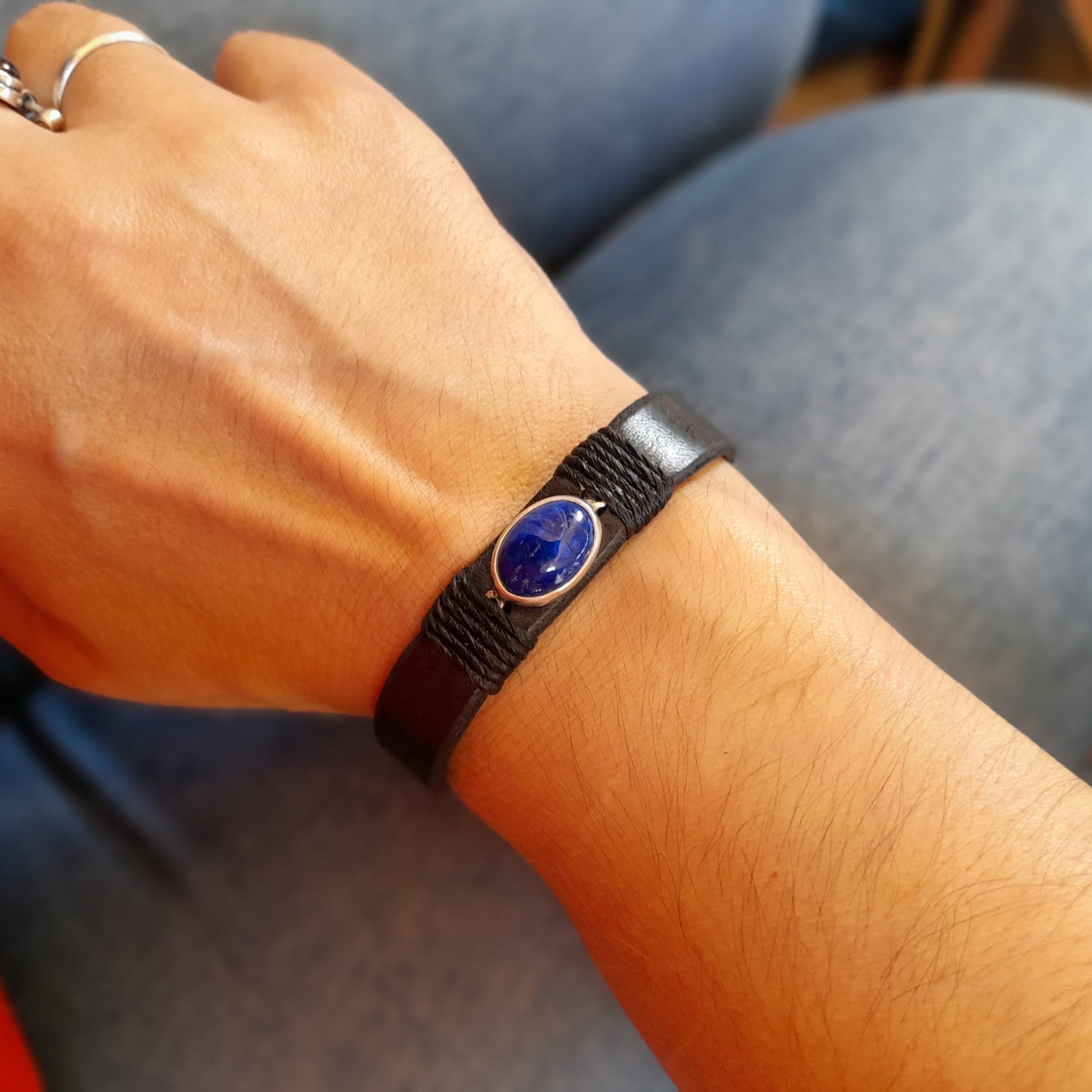 The Sodalite Clarity Bracelet worn on a wrist, demonstrating its comfortable fit, narrow design, and versatility for both men and women.