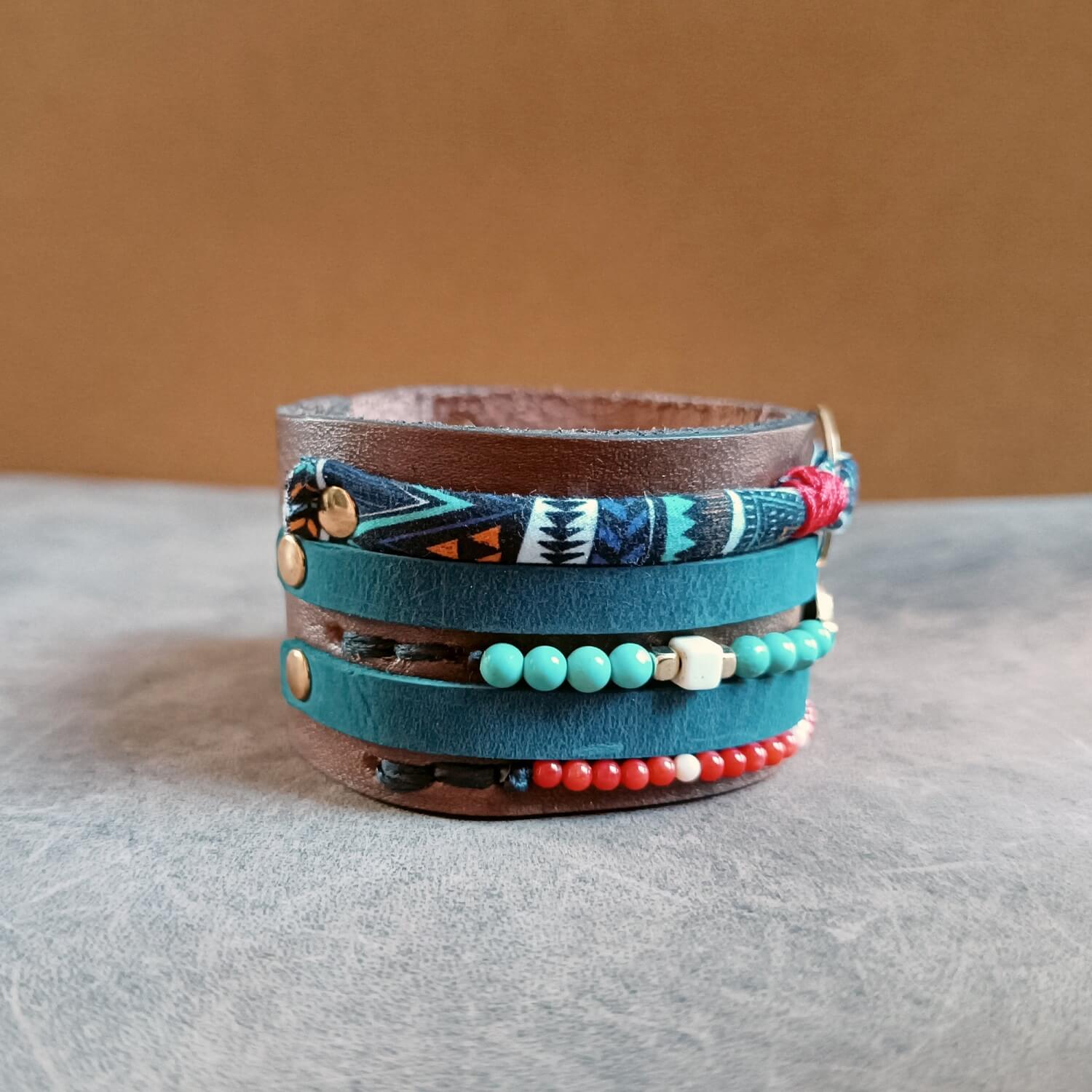 Multicolored leather wrap bracelet with beads, close up side view of rivets and stitching