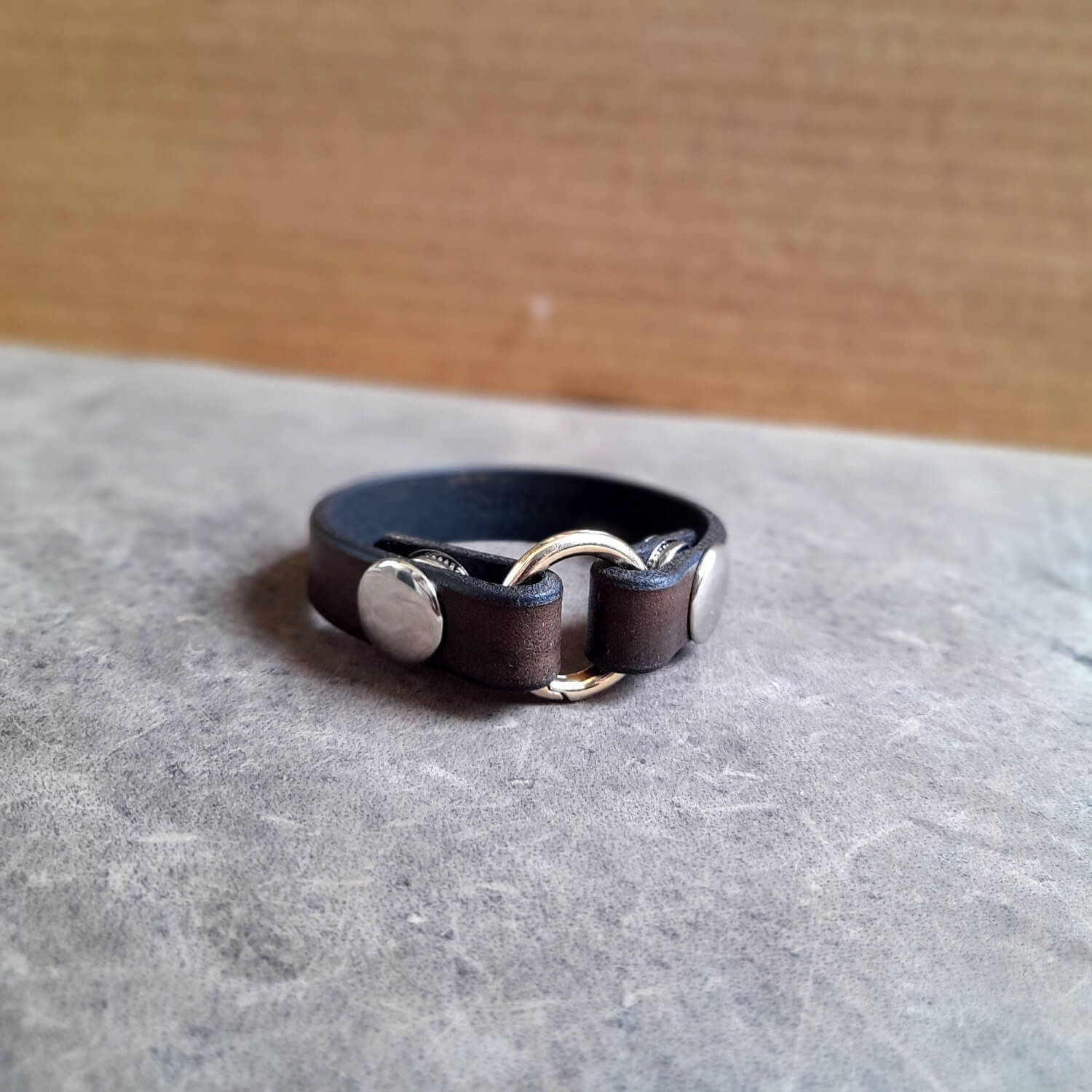 Side profile of the handmade chestnut brown leather ring holder bracelet.