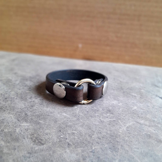 Side profile of the handmade chestnut brown leather ring holder bracelet.