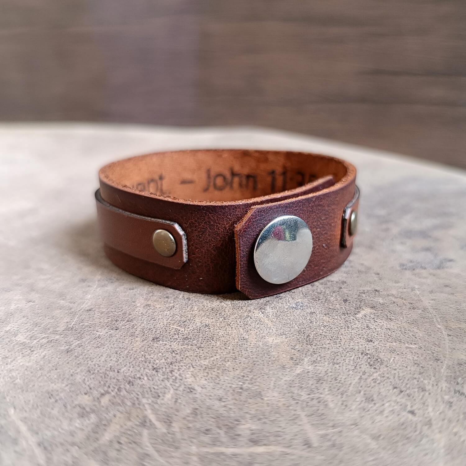 close up of the back side closure and underside of the rose gold cross leather cuff