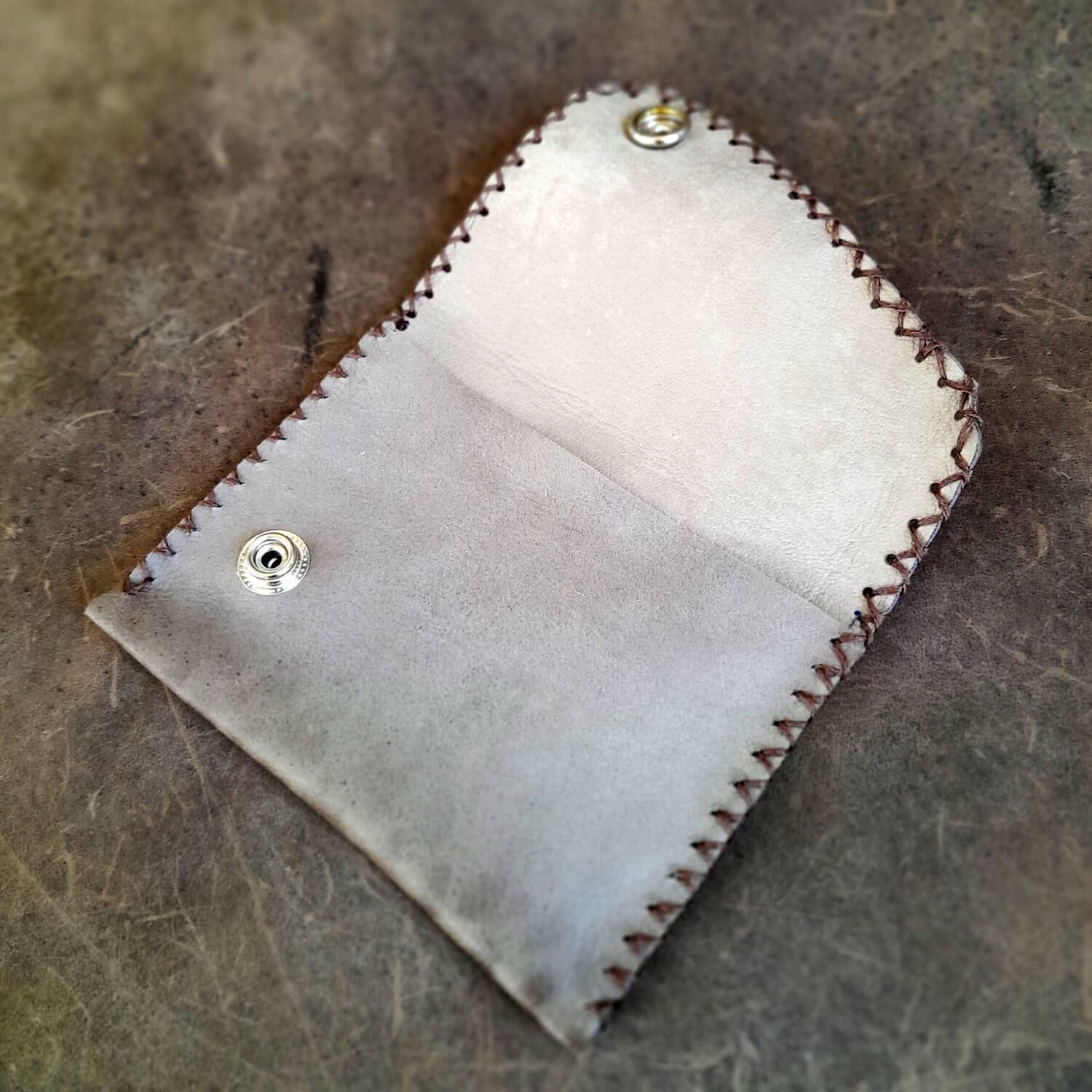 The Glossy Leopard Print Wallet open, revealing its single spacious compartment for cash, cards, and coins.