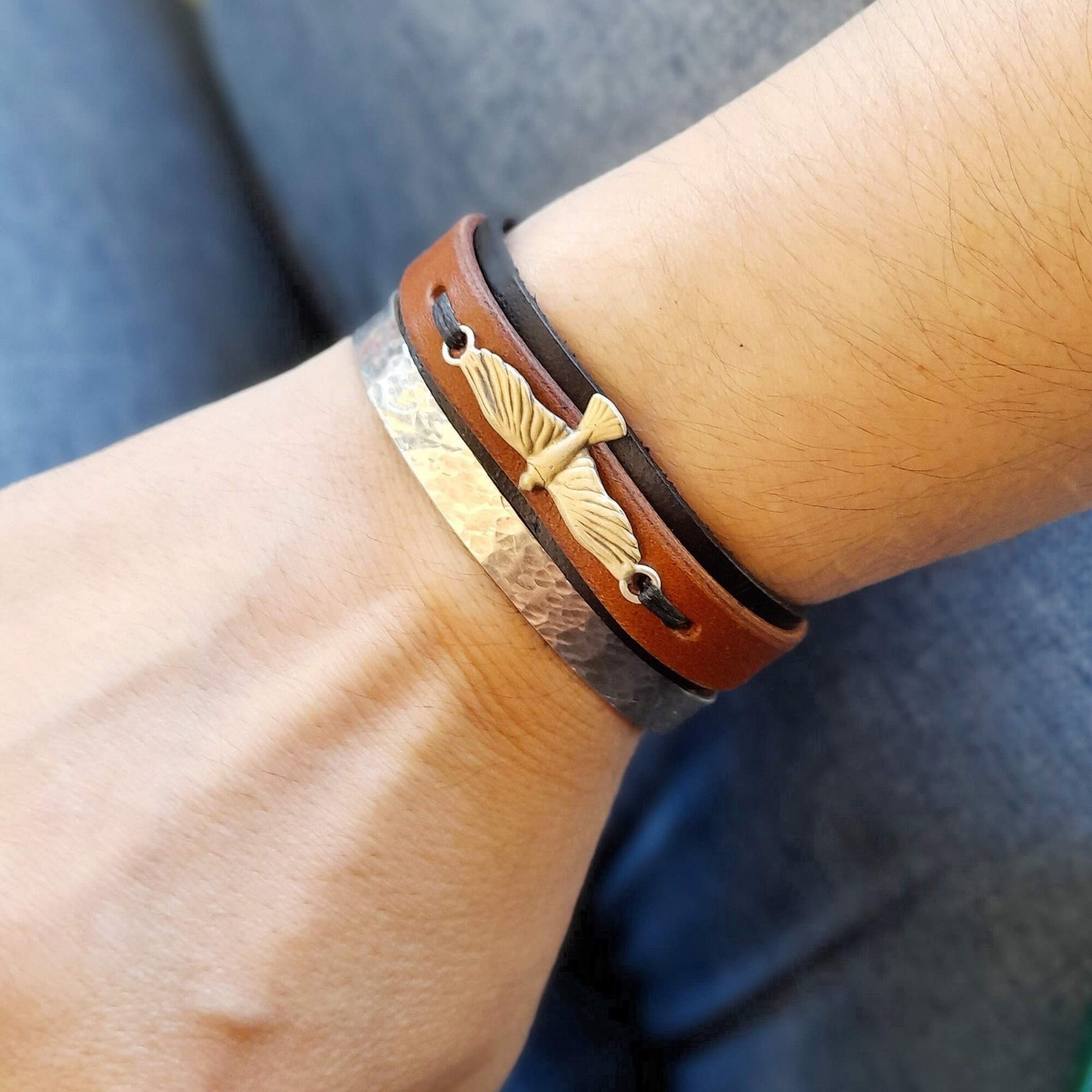 Close-up of a wrist wearing the Eagle leather bracelet, showcasing its stylish fit, layered design, and the eagle detail.