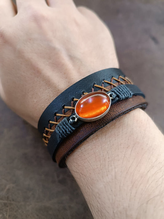 OOAK Greek Amber leather cuff bracelet worn on wrist, showcasing its artistic style and adjustable stainless steel snap closure.