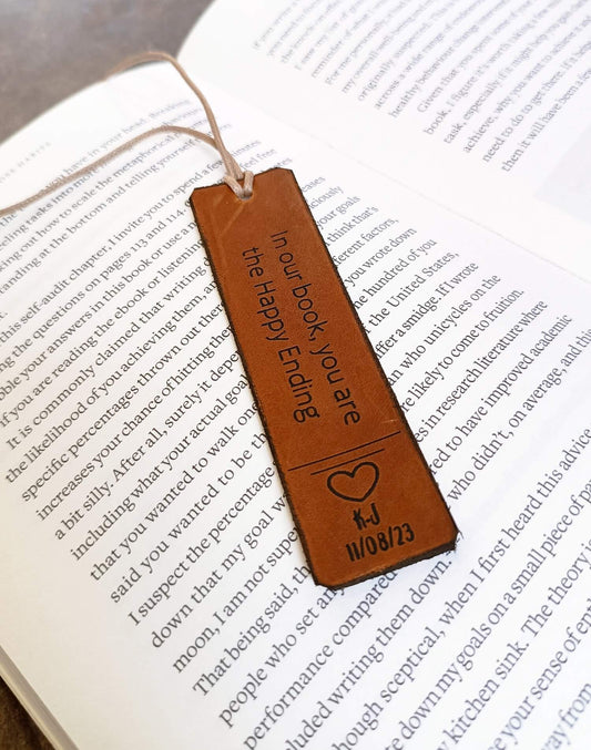 Brown leather bookmark with text and a heart design on an open book