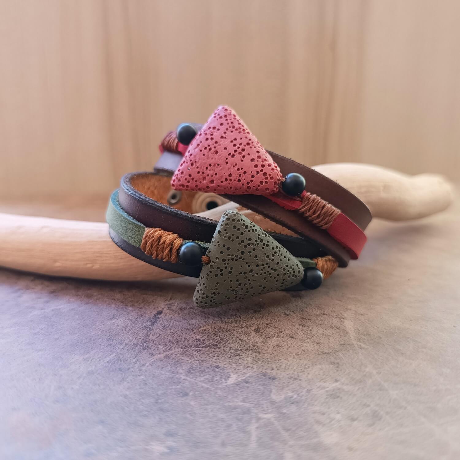 Detailed close-up of the porous lava beads on The Earth's Pulse Bracelets, highlighting its texture for essential oil diffusion, flanked by matte onyx beads and bronze cord.