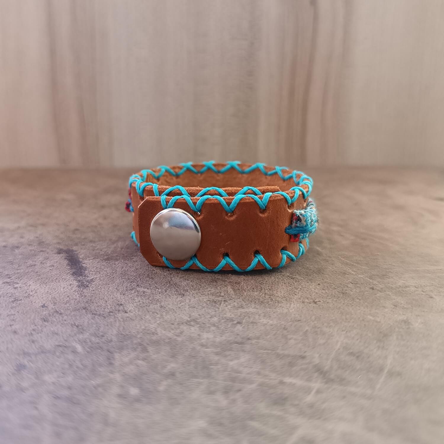 Back view of unisex leather bracelet featuring mustard brown Crazy Horse leather and stainless steel snap buttons for adjustable fit