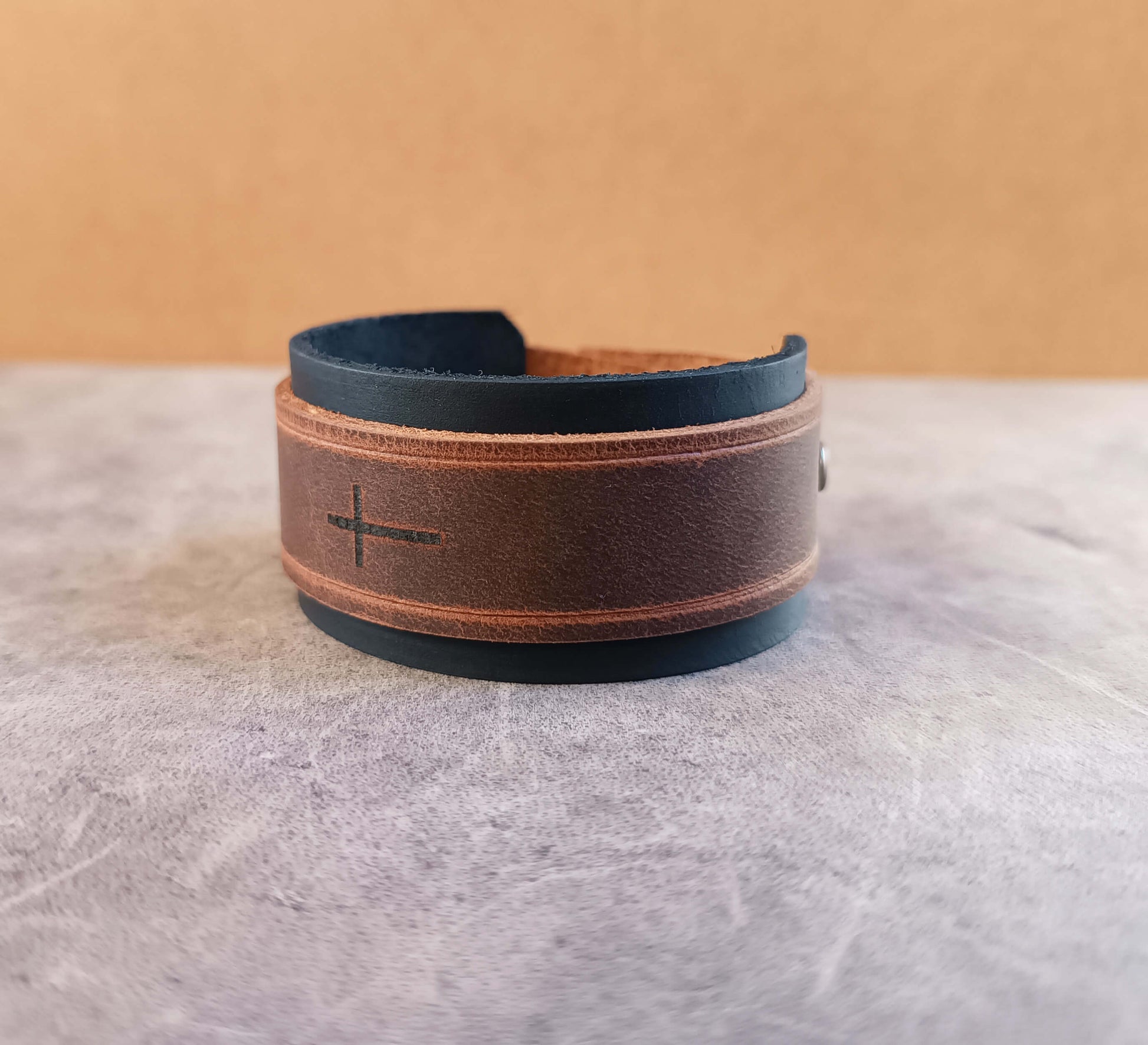 black brown leather cuff with engraved horizontal cross
