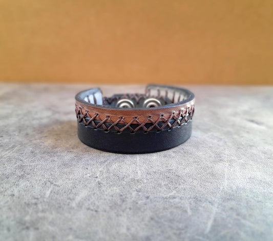 Leather bracelet with woven design on a textured surface