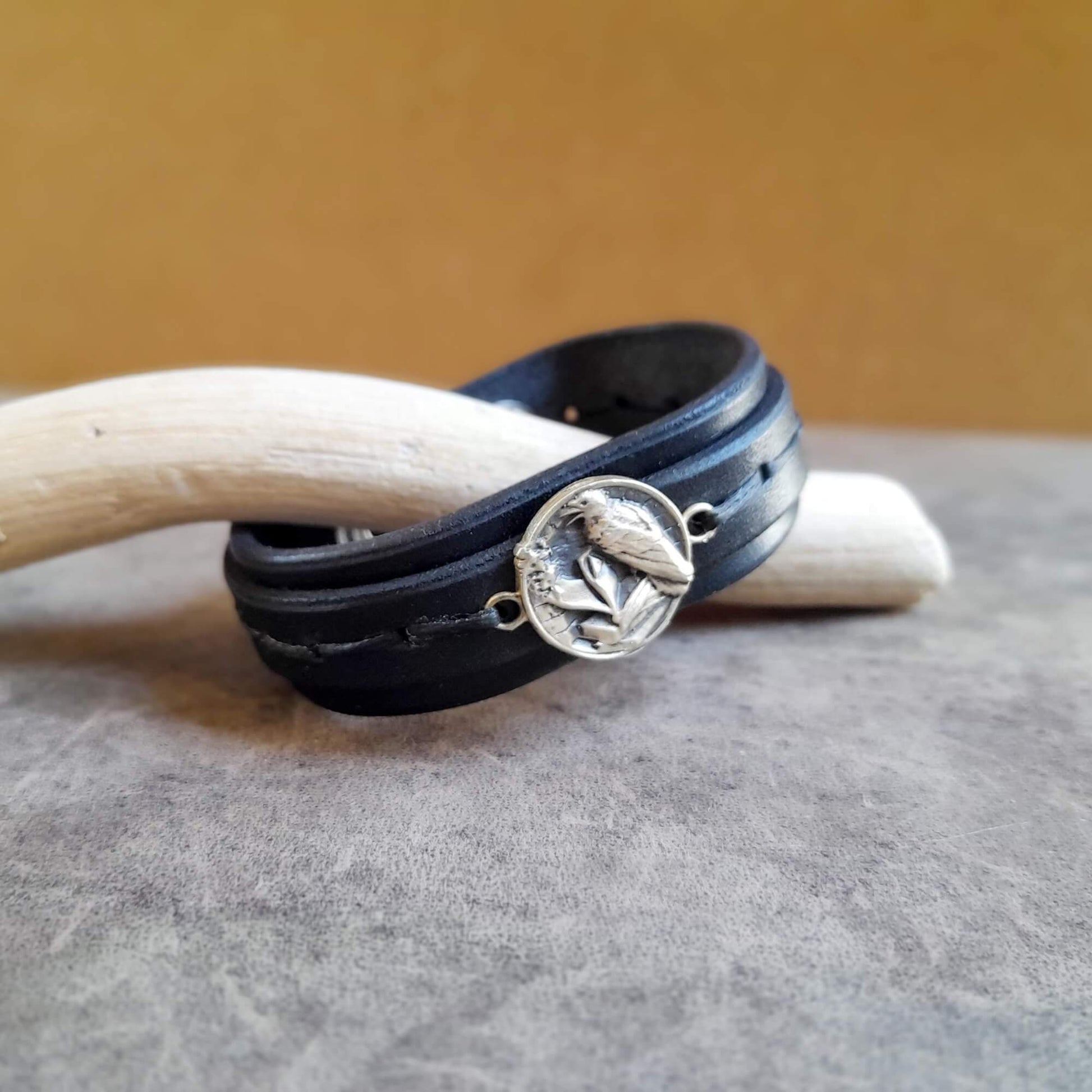 total black leather cuff with raven pendant