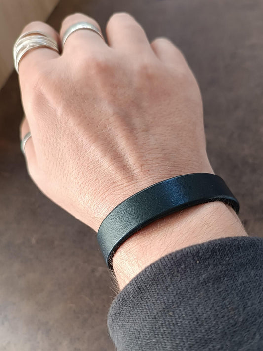 Personalized Black Vachetta Leather Bracelet on wrist with custom engraved hidden message