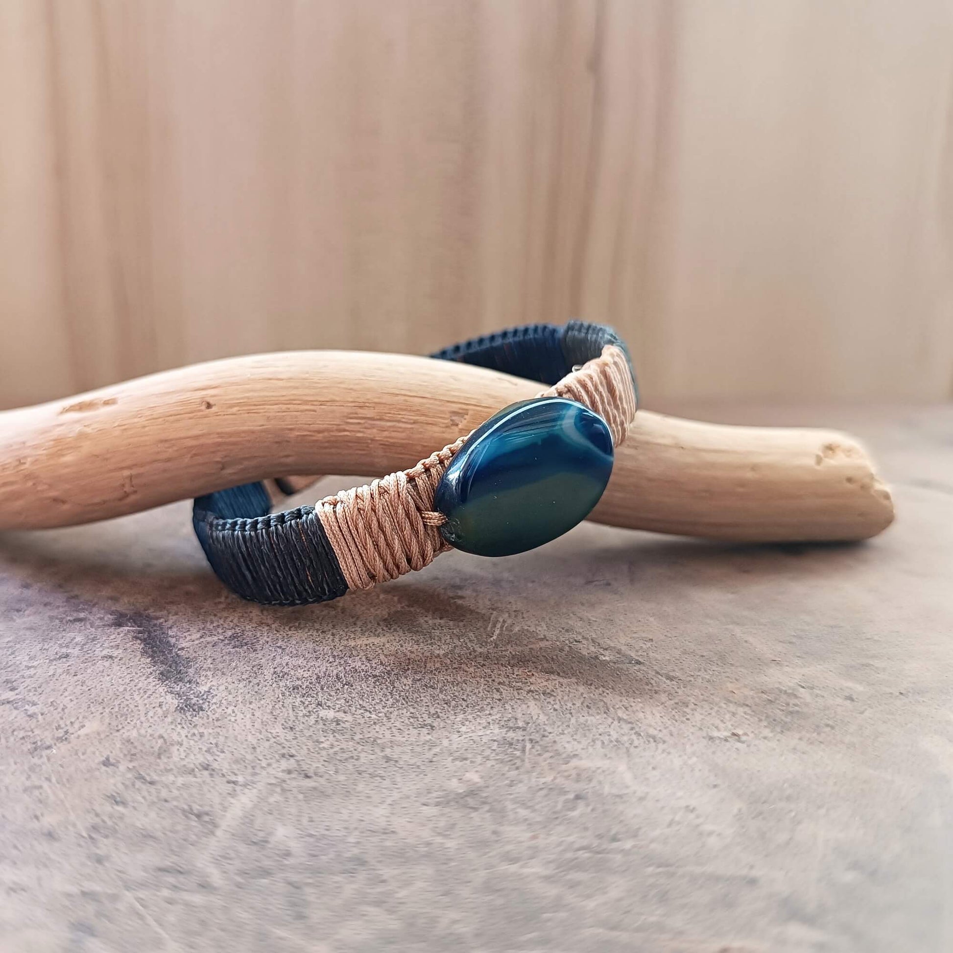 a leather bracelet with a blue agate stone close up side view
