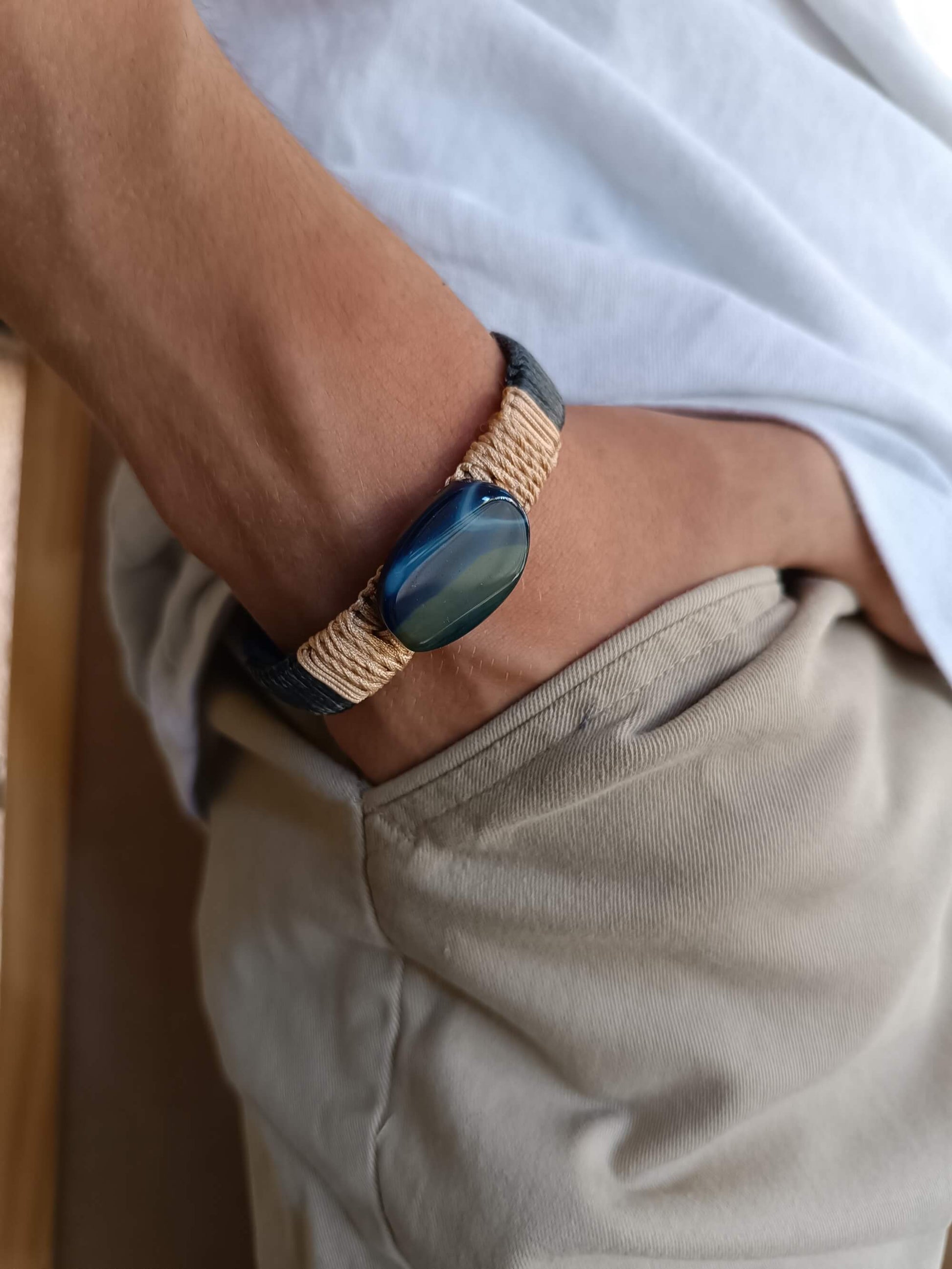 Man wearing a leather bracelet with a blue agate stone