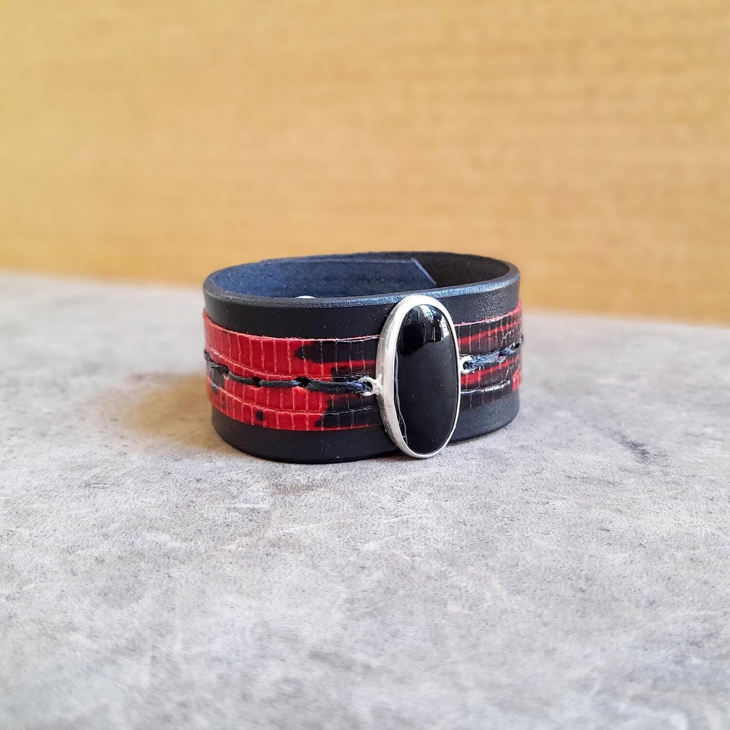Close-up of the glossy black obsidian stone set in the sterling silver pendant.