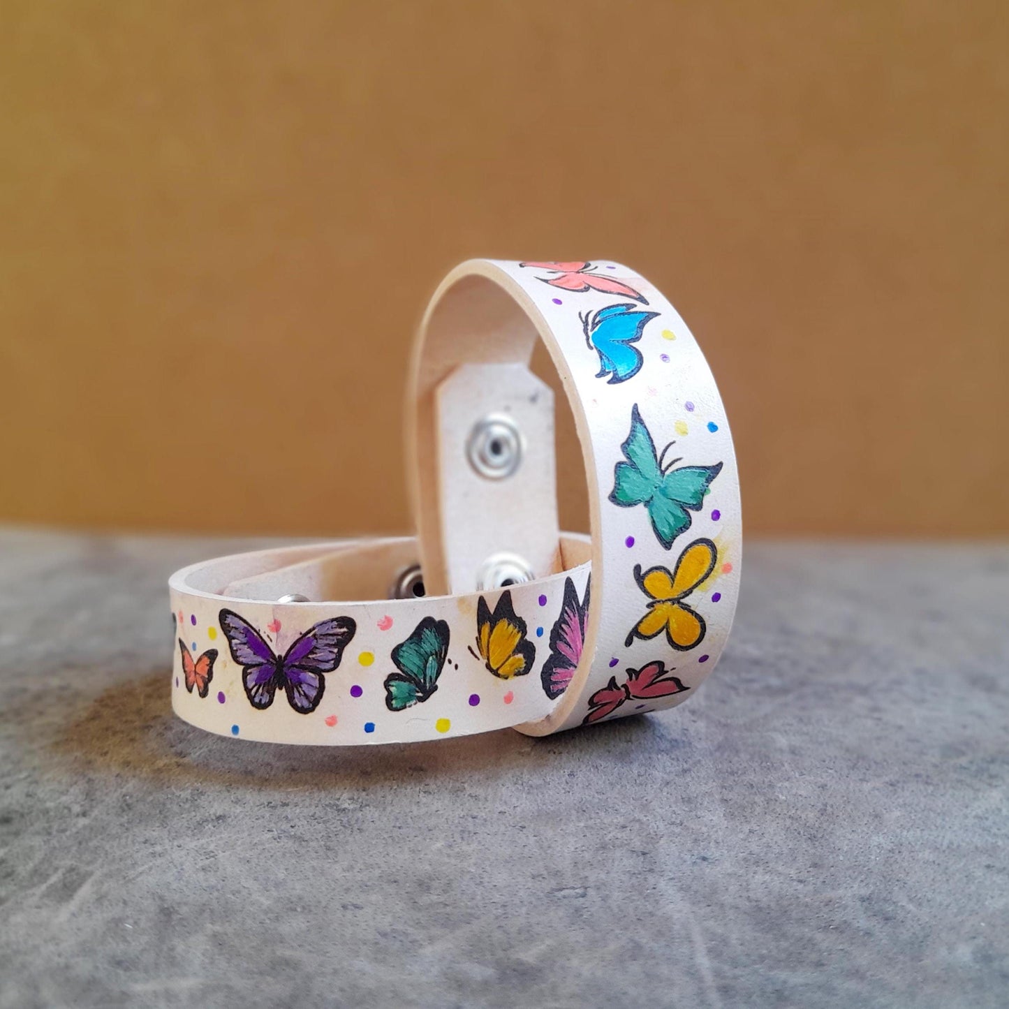 another close up of both butterfly bracelets, showcasing the vividness of colors and the cute polka dots