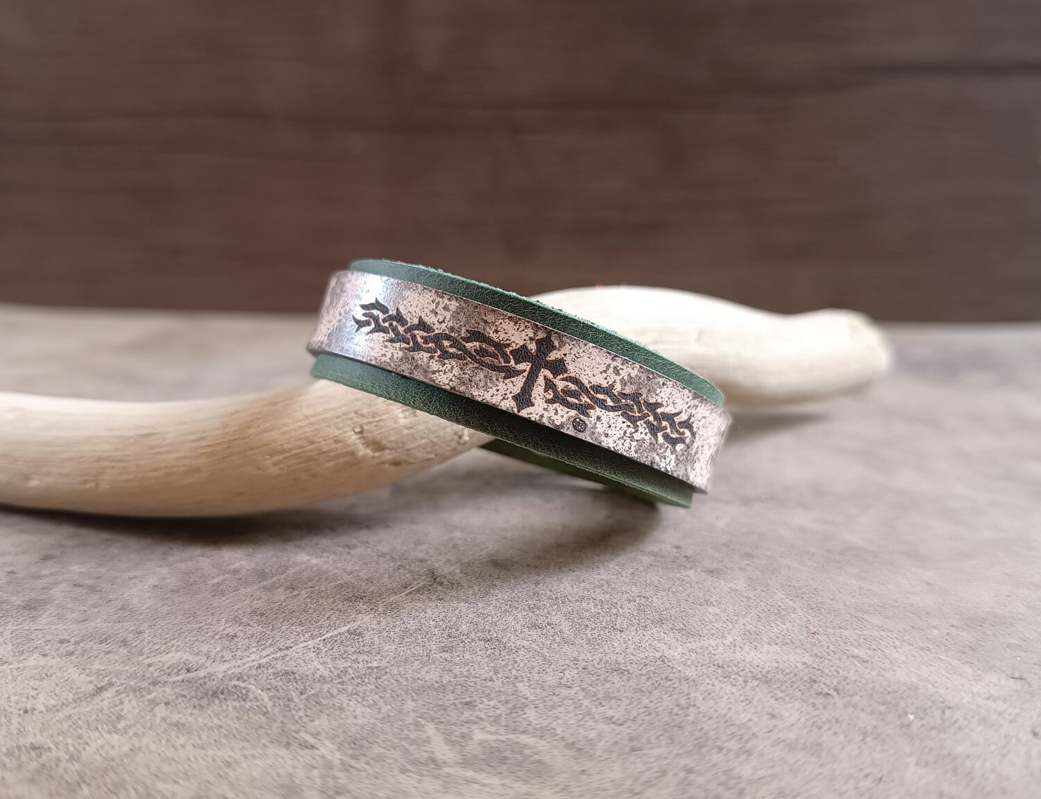 Bracelet with engraved design on a wooden surface