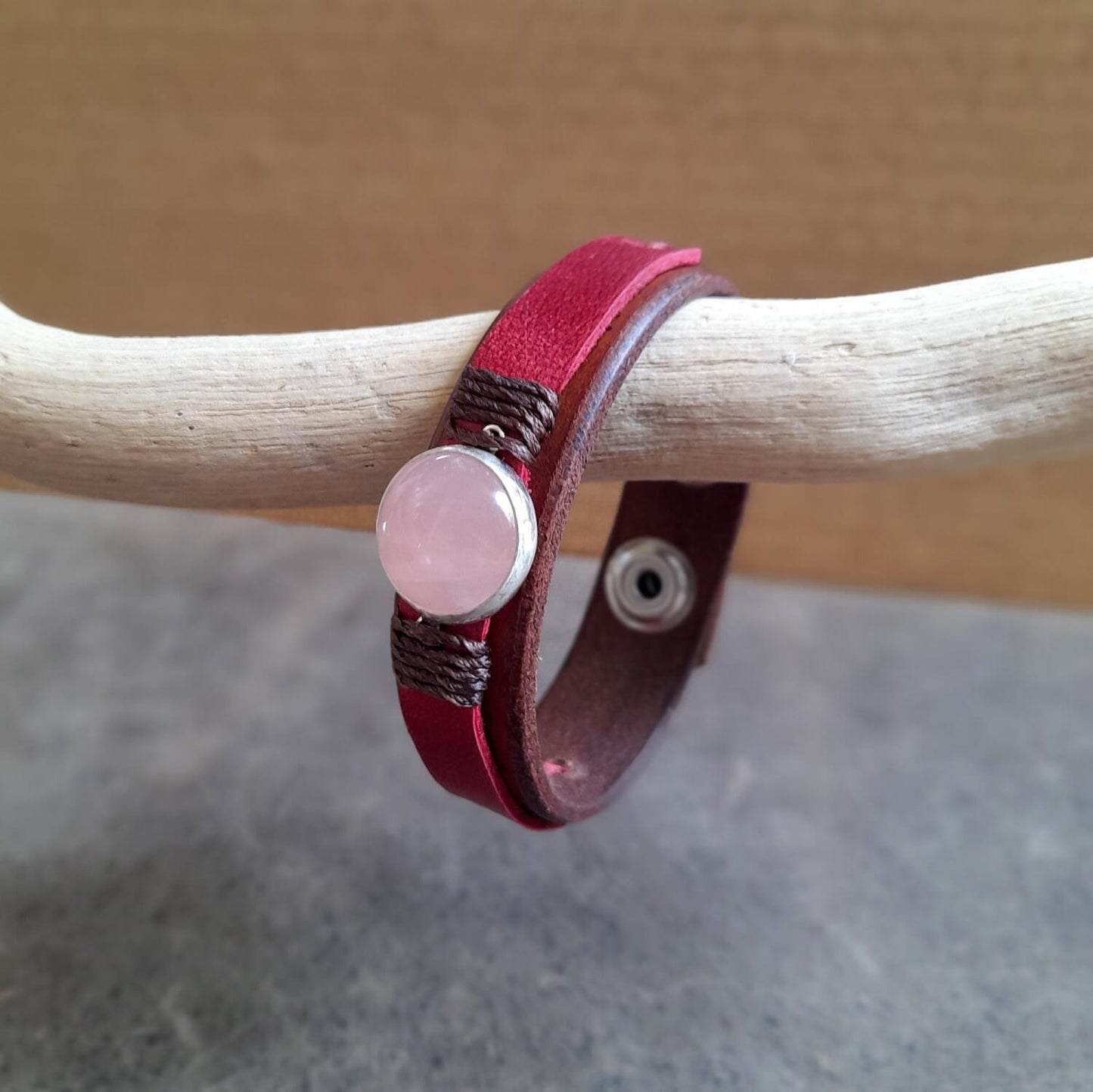 Detailed close-up of the natural rose quartz stone on the bracelet, highlighting its soft pink hues and sterling silver setting.