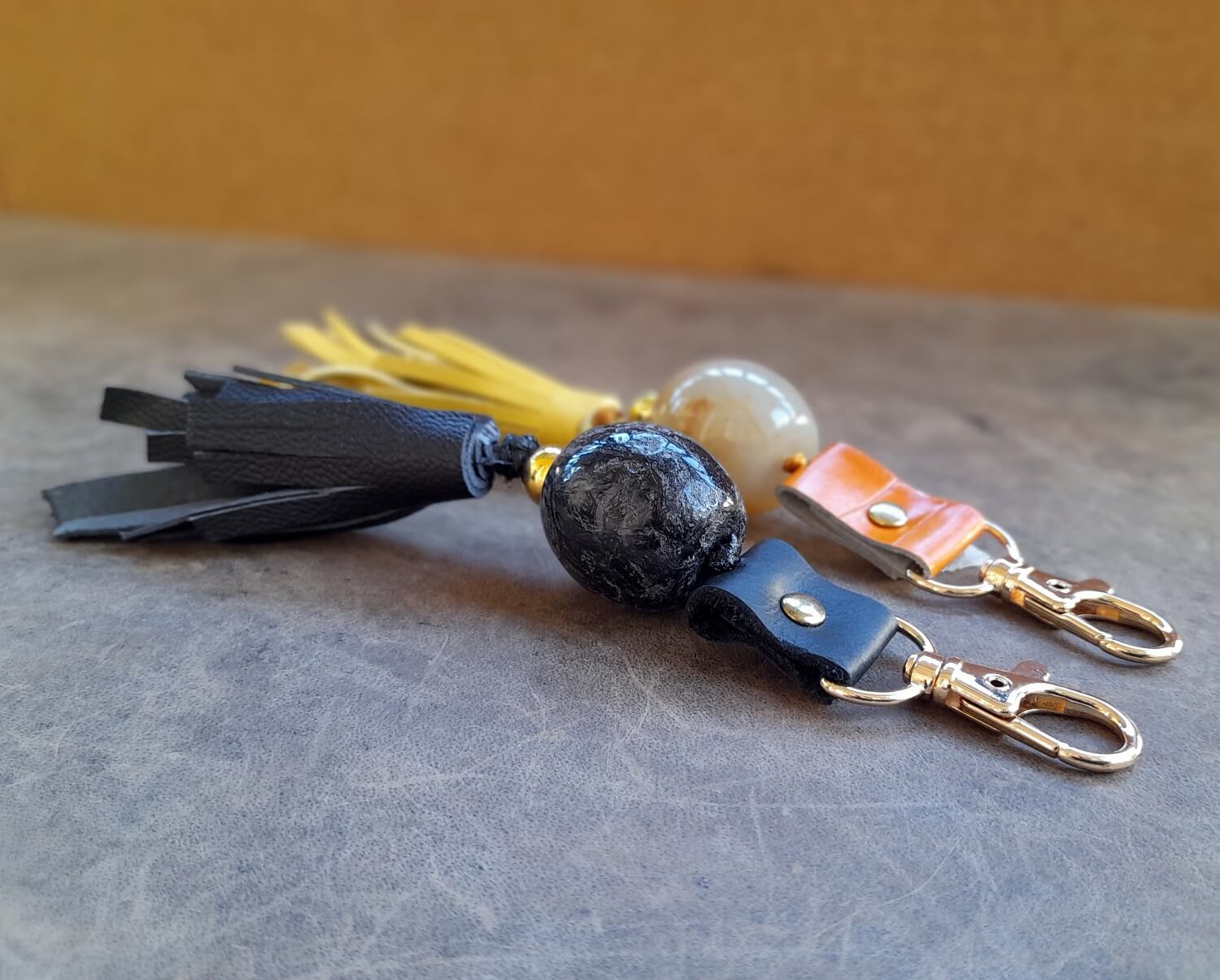 close up side angle of both tassel keychains
