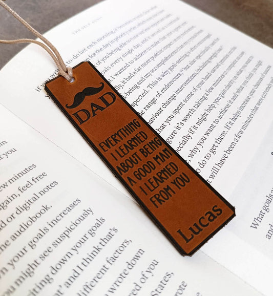 Brown leather bookmark with text on an open book