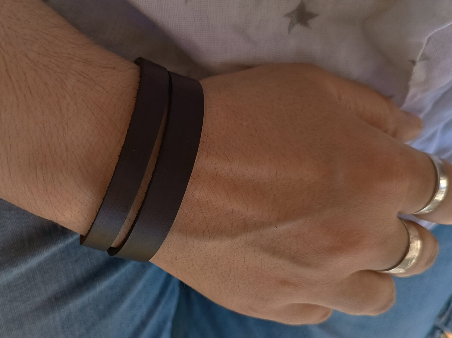 Unisex dark brown leather bracelet worn on woman's wrist, showing the double layer style