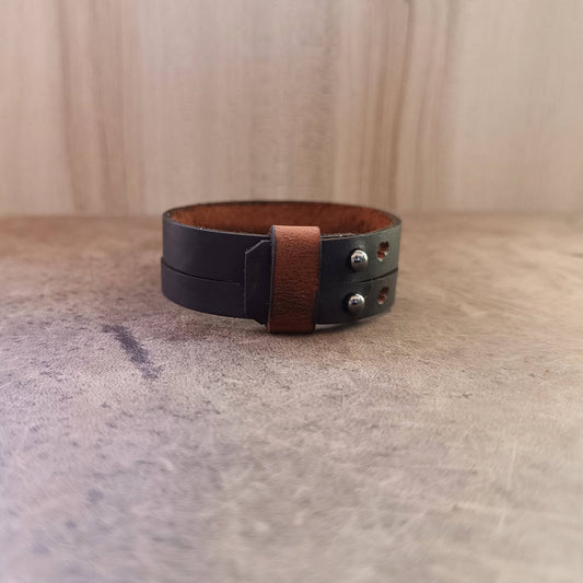 Minimalist dark brown leather cuff with loop and buttons, flat back view