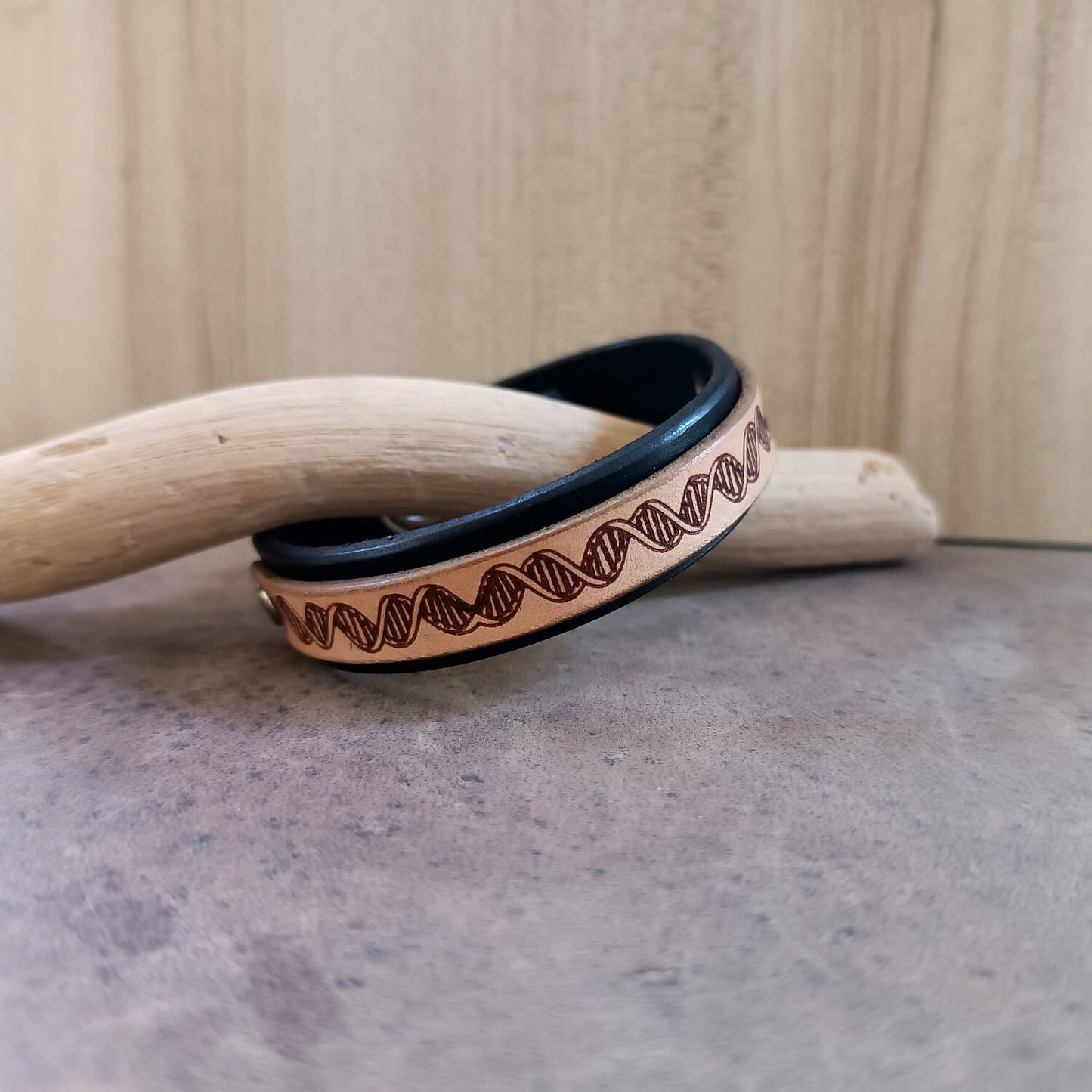 Bracelet with DNA pattern on a wooden background